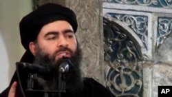 FILE - This image made from video posted on a militant website July 5, 2014, purports to show the leader of the Islamic State group, Abu Bakr al-Baghdadi, delivering a sermon at a mosque in Iraq.