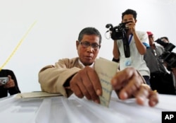 Officers of Union Election Commission transfer ballots that were cast in advance in foreign countries by Myanmar citizens as representatives of various political parties watch on in Naypyitaw, Myanmar, Tuesday, Nov. 3, 2015.