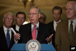 FILE - Senate Respublican Majority Leader Mitch McConnell, flanked by Republican colleagues, speaks to the media on Capitol Hill in Washington, Dec. 6, 2016.