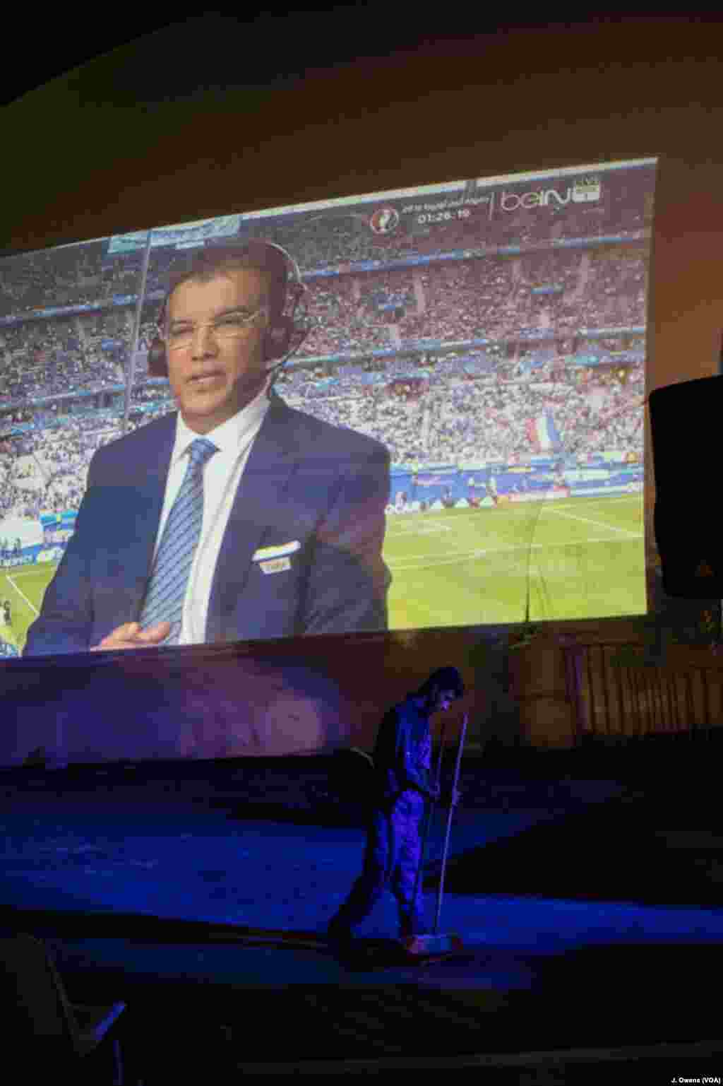 A cleaner walks past one of the five screens projected onto, and inside, the dome. 