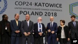Heads of the delegations react at the end of the final session of the COP24 summit on climate change in Katowice, Poland, Dec. 15, 2018.