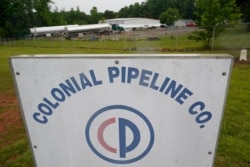 FILE - Tanker trucks are parked near the entrance of Colonial Pipeline Company, in Charlotte, N.C., May 12, 2021.