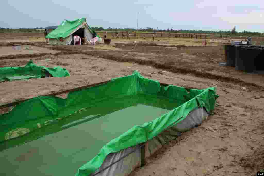 Water is stored in makeshift pools at a Muslim camp outside Kyauk Phyu, Rakhine State, Burma, November, 2012. (D. Schearf/VOA)
