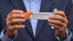 Sao Paulo Governor Joao Doria holds a package of the CoronaVac vaccine that arrived in Sao Paulo on November 19, 2020.