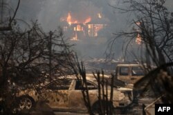 Fire consumes a home as an out of control wildfire moves through the area, Oct. 9, 2017 in Glen Ellen, California.