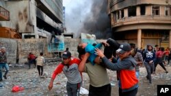 Pemorotes yang terluka dibopong untuk mendapat ptrawatan saat terjadinya bentrokan dengan petugas keamanan di Rasheed Street, Baghdad, Irak, 28 November 2019. 