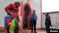 Pan Yinbao, a priest for Yingtan with the official church backed by the Beijing-controlled Catholic Patriotic Association, speaks with a faithful outside the church in Yingtan, Jiangxi province, China, March 25, 2018. 