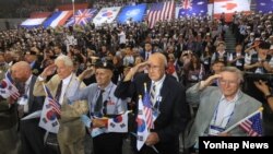 27일 서울 올림픽공원 핸드볼경기장에서 열린 '정전협정 64주년 및 유엔군 참전의 날' 기념식에서 6·25 참전용사들이 국기에 대한 경례를 하고 있다. 
