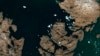 Iceberg Looming Over Greenland Village Spotted From Space