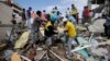 Volunteers rescue a body from a destroyed house after a massive earthquake in Pedernales, Ecuador, April 17, 2016. 