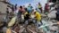 Volunteers rescue a body from a destroyed house after a massive earthquake in Pedernales, Ecuador, April 17, 2016. 