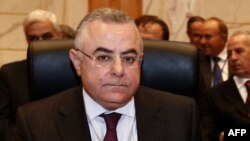 FILE - Governor of Egypt's Central Bank Hisham Ramez (L) attends opening session of the Arab Finance Ministers meeting in Dubai, April 2, 2013.