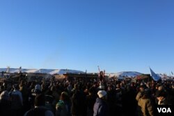 Water protectors celebrate the decision of the Army Corps to deny the building of the Dakota Access Oil Pipeline through their and sacred Sioux land (E. Sarai/VOA)