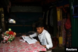 Kefayat Ullah, a Rohingya boy who was expelled from Leda High School for being a Rohingya, studies in his shelter in Leda camp in Teknaf, Bangladesh, March 5, 2019. REUTERS/Mohammad Ponir Hossain