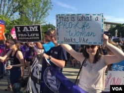 Pro-life demonstrators wave signs and make their voices heard after the Supreme Court upheld abortion rights in a 5-3 decision, in front of the Supreme Court building in Washington, June 27, 2016. (J. Oni / VOA)
