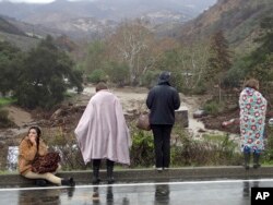Rescued campers survey the scene at the El Capitan Canyon campground following flooding due to heavy rains, in Gaviota, Calif., Jan. 20, 2017.