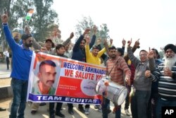 FILE - Indians dance as they wait to welcome Indian fighter pilot Wing Commander Abhinandan Varthaman at India Pakistan border at Wagah, 28 kilometers (17.5 miles) from Amritsar, India, March 1, 2019.