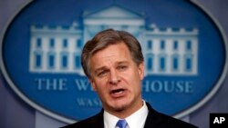 FILE - FBI Director Christopher Wray speaks during the daily press briefing at the White House, Aug. 2, 2018, in Washington.