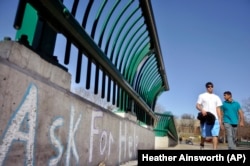 Cornell University students cross the college's Thurston Avenue Bridge in Ithaca, NY.