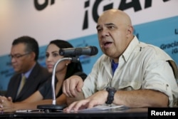 FILE - Jesus Torrealba (R), secretary of the Venezuelan coalition of opposition parties (MUD), speaks during a news conference in Caracas, Dec. 8, 2015.