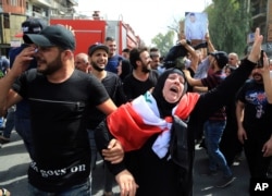 Iraqis grieve during the funeral procession of bomb victim, Akram Hadi, 24, who was killed in a massive truck bomb attack in the Karada neighborhood of Baghdad, Iraq, July 5, 2016.