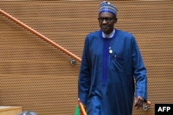 FILE - Nigeria's President Muhammadu Buhari walks after speaking at the opening of the Ordinary Session of the Assembly of Heads of State and Government during the 30th annual African Union summit in Addis Ababa, Jan. 28, 2018.