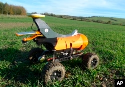 A farming robot named "Tom" produced by Small Robot Company as part of a field trial to develop new farm technologies, in East Meon, southern England, Friday Nov. 30, 2018. (AP Photo / Kelvin Chan)