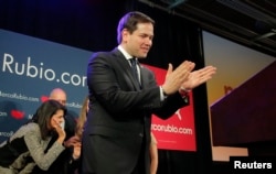 U.S. Republican presidential candidate Marco Rubio applauds as he approaches the podium to speak to supporters at a South Carolina primary night rally in Columbia, S.C., Feb. 20, 2016.
