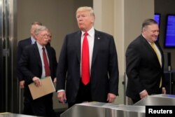 U.S. President Donald Trump arrives at United Nations headquarters with Secretary of State Mike Pompeo (R) and National Security Advisor John Bolton (L) during the 73rd United Nations General Assembly in New York, Sept. 24, 2018.