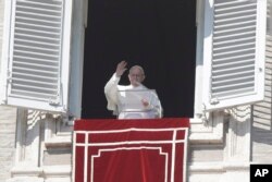 Pope Francis delivers his blessing during the Angelus noon prayer In St. Peter's Square at the Vatican, Feb. 17, 2019.