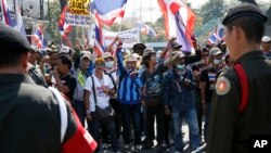Thai soldiers stand in front of anti-government protesters during a rally during the cabinet meeting at the Army Club, Jan. 28, 2014 in Bangkok, Thailand.