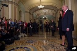FILE - President-elect Donald Trump, accompanied by his wife Melania, speaks to the media on Capitol Hill in Washington, Nov. 10, 2016.