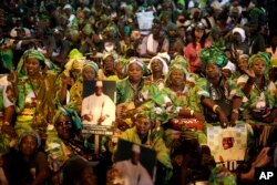 Supporters cheer Gambian President Yahya Jammeh during his final rally in Banjul, Gambia, Tuesday Nov. 29, 2016.