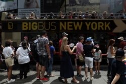 Para turis antre untuk menaiki bus wisata kota New York yang sangat populer sebelum datangnya pandemi (foto: dok).