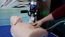 This photo shows a robot designed to help medical workers treat coronavirus patients remotely is pictured during a demonstration for the media at the aerospace engineering school of Tsinghua University in Beijing, China March 4, 2020. (REUTERS/Carlos Garc