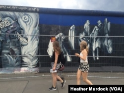 Much of the wall is painted, with artists displaying everything from the horrors of suffering to unity, June 30, 2016.