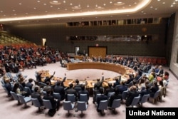 Ambassadors to the U.N. vote during a United Nations Security Council meeting on North Korea in New York City, Sept. 11, 2017.