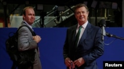 FILE - Paul Manafort, right, campaign manager to Republican Presidential Candidate Donald Trump, and his assistant Rick Gates stand on the floor of the Republican National Convention in Cleveland, July 17, 2016.