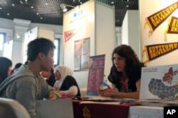 A recruiter answers questions from an Indonesian student looking to study in the US, at a US education fair sponsored by the US Embassy in Jakarta, April 4, 2011