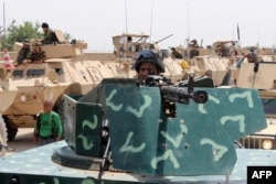Afghan security personnel stand alert as they prepare for an operation against Taliban militants in the Aliabad district of Kunduz province, June 12, 2016.