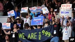 Delegates hold signs and cheer support as the state by state roll call continues