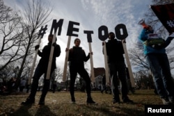 Demonstrators spell out "#MeToo" during the local second annual Women's March in Cambridge, Mass., Jan. 20, 2018.