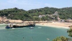 A confiscated Chinese sand-dredging ship discharges the sand back at coast after being caught by Taiwanese coast guard, in Nangan township, Lienchiang county, July 17, 2020 in this screen grab obtained from a social media video. (Aya Liu/via REUTERS)