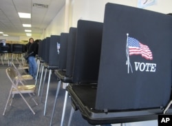 FILE - Members of the Native American Voters Alliance mark their ballots at an early voting center in Albuquerque, N.M., Oct. 26, 2012. (AP Photo/Susan Montoya Bryan)