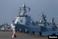 Chinese navy officers of the People's Liberation Army stand guard near ships during a Russia-China naval drill at a port in Zhanjiang, Guangdong province, China, September 12, 2016. Picture taken September 12, 2016.