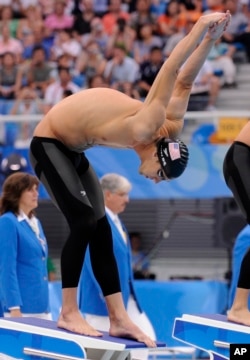 FILE - The United States' Michael Phelps prepares for a men's 200-meter individual medley semifinal in the National Aquatics Center at the Beijing 2008 Olympics, Aug. 14, 2008. Speedo was on the cutting edge of the swimsuit wars with its LZR Racer, which became the go-to attire heading into the 2008 Olympics.