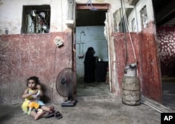 A Palestinian refugee widow, Um Jibrel, 48, prepares salad for the Iftar meal to break the Ramadan fast in the al-Baqa'a Palestinian refugee camp, in Amman, Jordan, August 21, 2011.