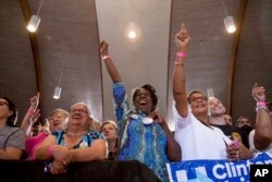 FILE - A woman in the audience, center, holds out her button that reads "Nasty Woman" as Democratic presidential candidate Hillary Clinton speaks at a rally at Sanford Civic Center in Sanford, Fla., Nov. 1, 2016.