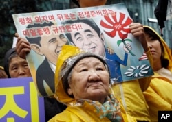 FILE - Former comfort woman Kil Un-ock who was forced to serve for the Japanese troops as a sexual slave during World War II, attends a rally against a visit by Japanese Prime Minster Shinzo Abe to the United States, in front of the Japanese Embassy in Seoul.