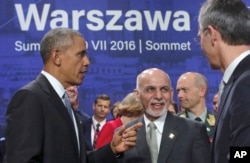 Afghan President Ashraf Ghani, center, speaks with U.S. President Barack Obama and NATO Secretary General Jens Stoltenberg at the NATO summit in Warsaw, Poland, July 9, 2016.